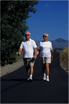 a photo of an elderly couple walking in the park