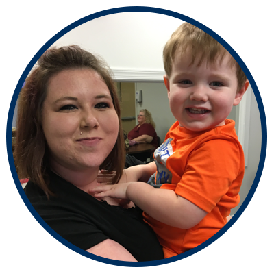 a photo of a mom holding her son whose a toddler