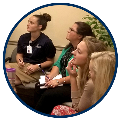 a photo of a group of students listening to a lecture