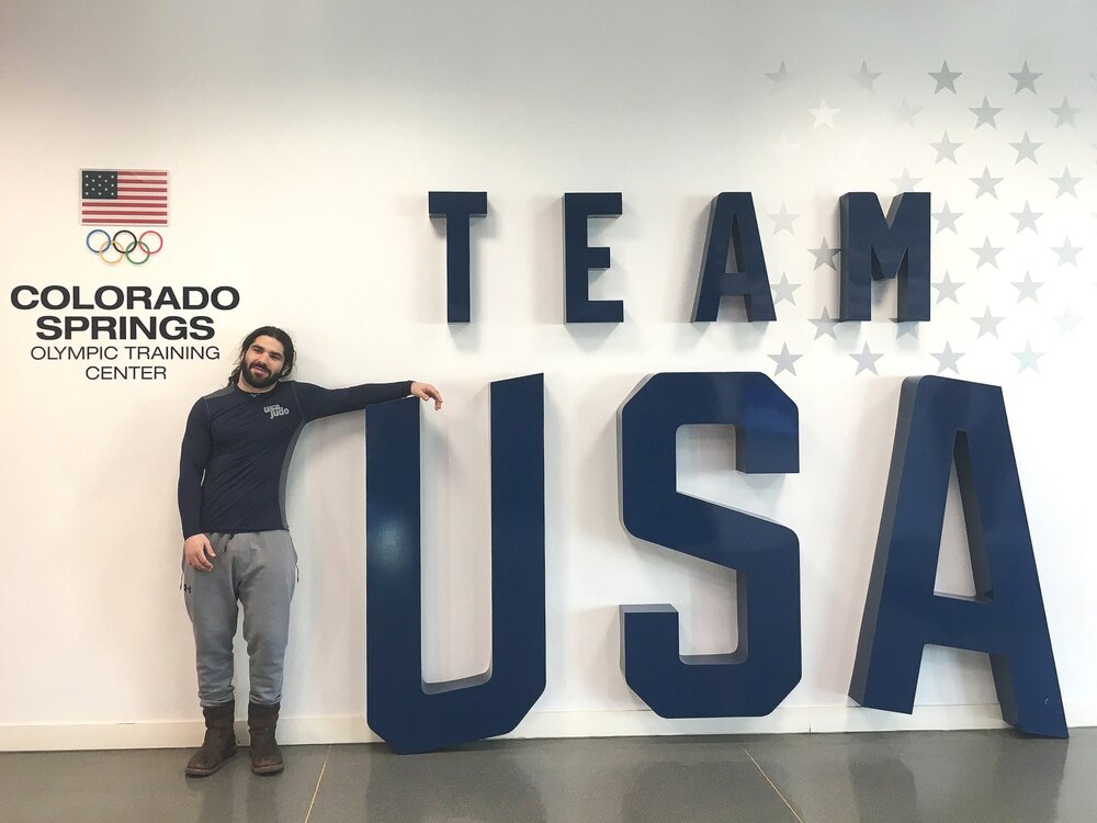 Anthony Ferraro standing next to a Team USA sign
