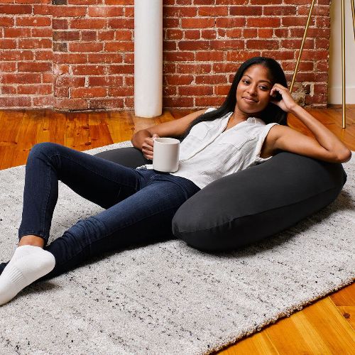a photo of a woman lounging on the Yogibo pillow