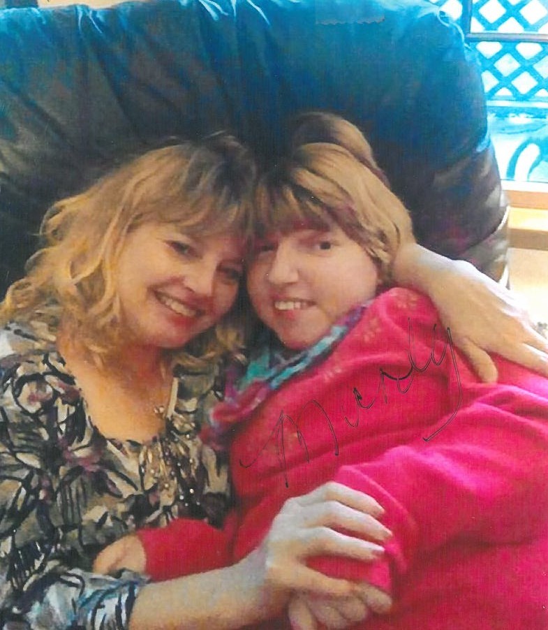 Carrie and Mandie hugging in a chair