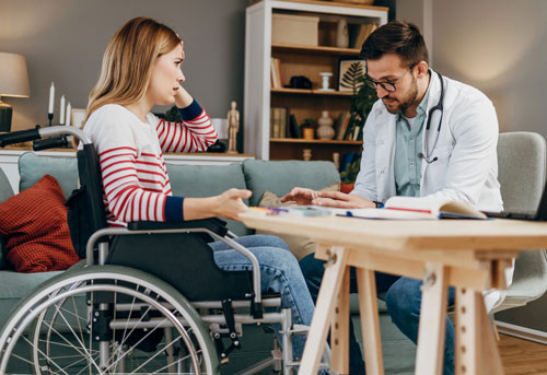 a woman in a wheelchair looking exasperated talking to a doctor